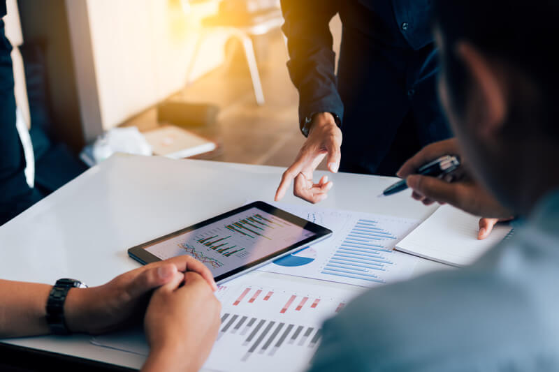 Business people analysis finance reports and working together on desk.