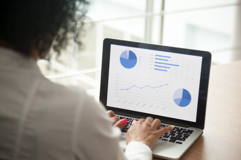 African project manager using computer software analyzing financial market rates
