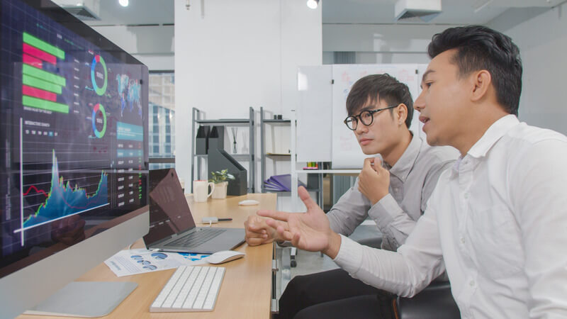 4K resolution footage two Asian business man discussion ans analysis financial data by computer,Investment analysis financial data concept,Asian office business life indoor